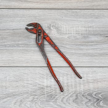 a pipe wrench on a wooden table