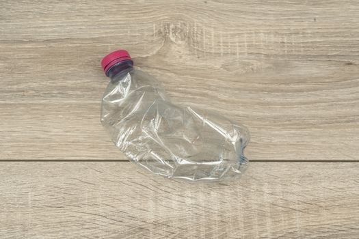 a crushed and abandoned plastic bottle