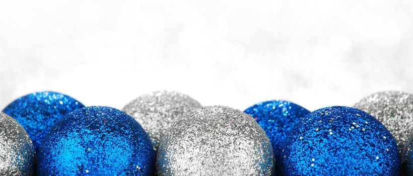 Chritmas balls on glitters with bokeh background