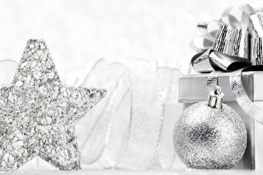 Christmas gift and decoration on shiny glitter background