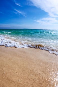 Wave of the sea on the sandy tropical beach