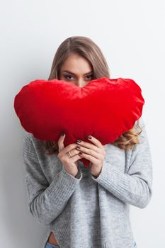 Beautiful woman with red pillow heart, valentine's day concept