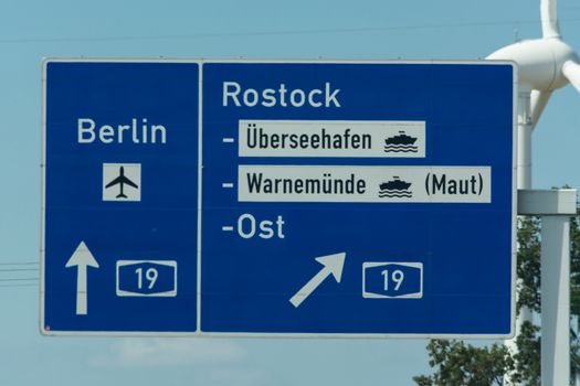 Highway sign in Germany Caption on German - city names Berlin,Berlin Airport, Rostock, Lübeck