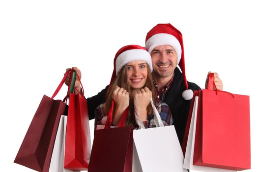 Happy beautiful couple holding many bags with christmas gifts isolated on white background