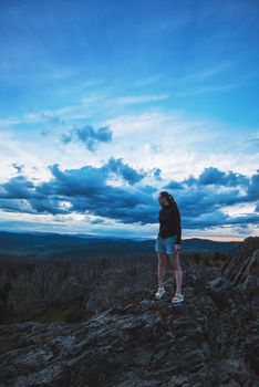 Travel, lesure and freedom concept - woman on the top of Altai mountain, beauty summer evening landcape