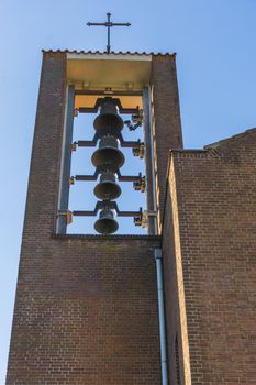 group of ringing church bells hanging in a church tower