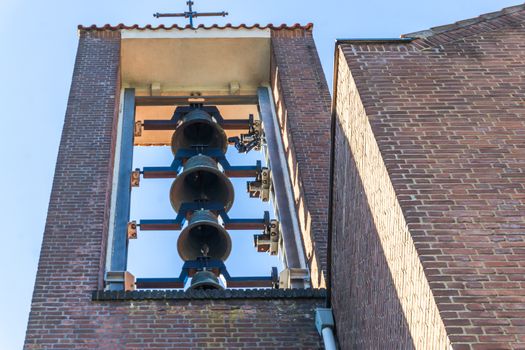 group of church bells hanging in a church tower for ringing
