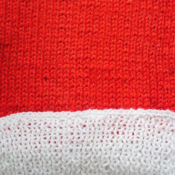 Red and white knitted woolen background with copy space for text Christmas concept