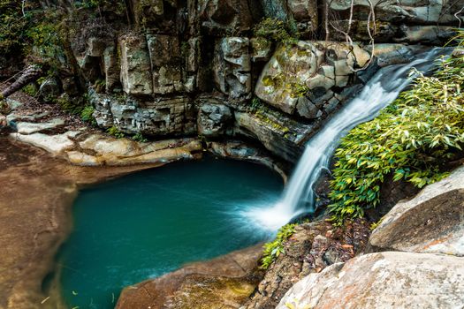 Little waterfall flowing into a rock pool in the lush canopy of Illawarra  Escarpment Macquarie Pass