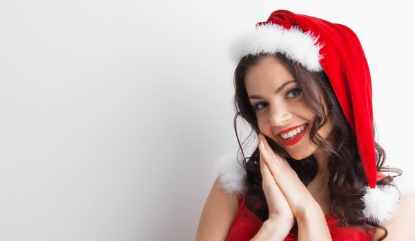 Pretty Pin-up style Santa girl in red hat on white background