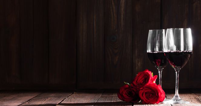 Two glasses of red wine and three roses, Valentine day