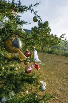 Decorated Christmas tree in the forest at nature background.