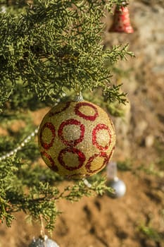 Decorated Christmas tree in the forest at nature background.