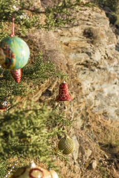 Decorated Christmas tree in the forest at nature background.