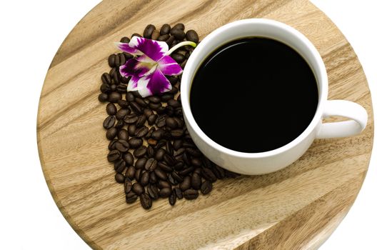 Coffee cup and coffee beans on wooden background