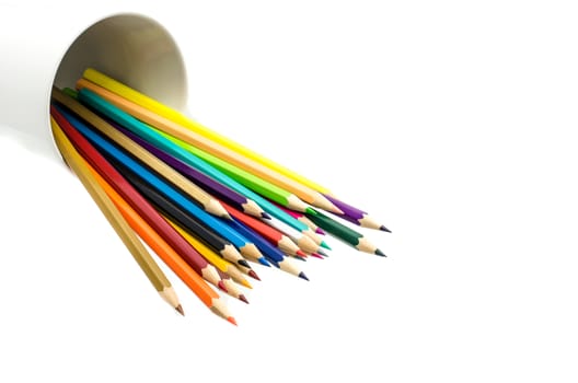 Stack of colored pencils in a glass on white background