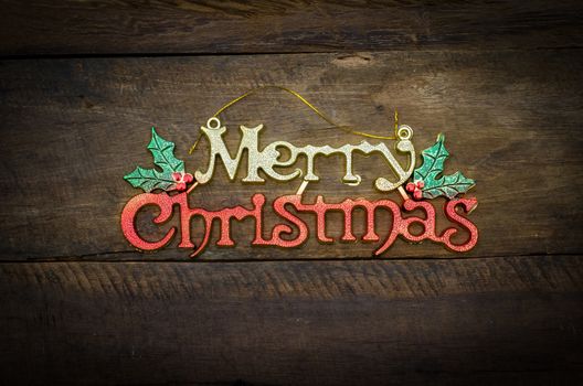 Merry Christmas greeting message on wooden background