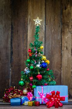 Christmas tree with colorful ornaments a wood background