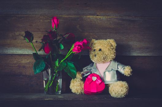 Doll and Roses on wooden background