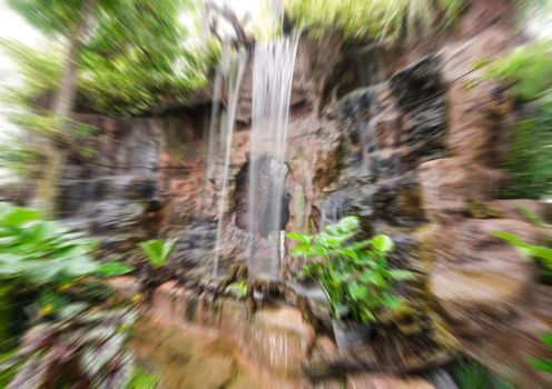 Blur beautiful waterfall in the forest trees