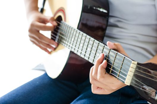 Girl playing guitar - Focus hand.