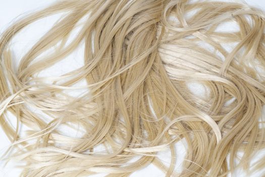 long blonde hair lying on a white surface
