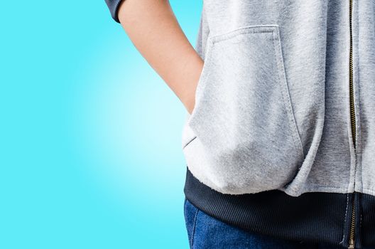 Hand in his pocket shirt on blue background.