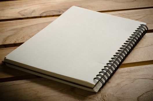 White notebooks laying on a wooden table