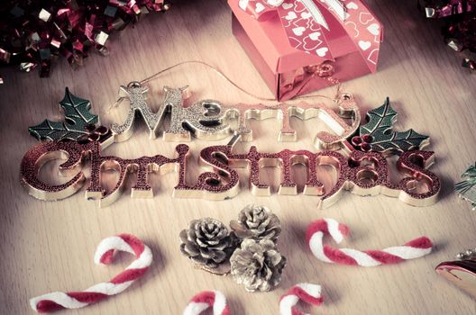 Merry Christmas greeting message on wooden background
