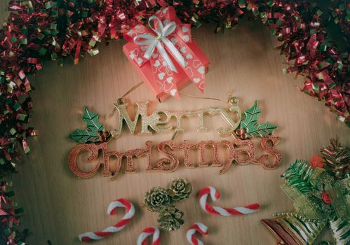Merry Christmas greeting message on wooden background