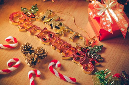 Merry Christmas greeting message on wooden background
