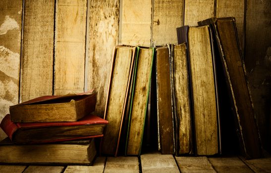 Old books on the wooden background.
