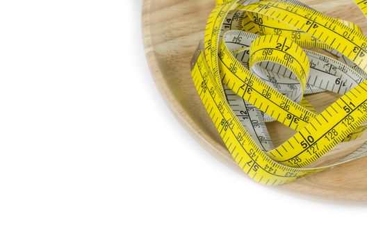 Yellow tape measure on plate concept diet.