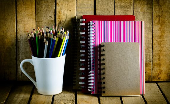 color pencil notebook on a wooden table.