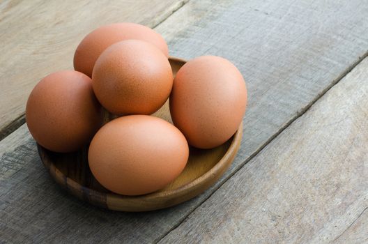 Place the egg in a cup on wood