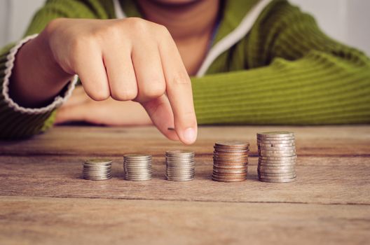 hand put the coin on each line rising - business concept