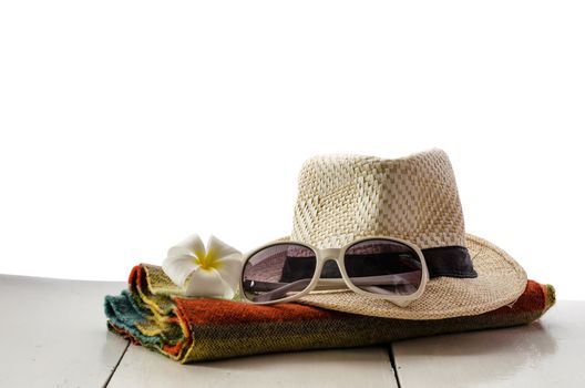 Hats, glasses, scarves, flowers are placed on a wooden floor with white background