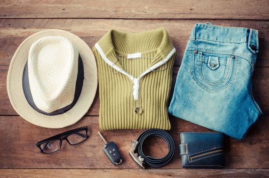 Travel accessories. Shirts, jeans, hats, belts, wallets, glasses, car keys ready for the trip.