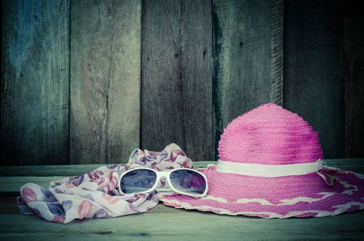 Travel accessories for young women Sombrero pink scarf sunglasses.on wood