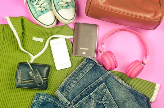 Travel accessories, bags, shoes, hats, scarves, sunglasses, headphones, smart phones, passports ready for issuing travel vintage tone.