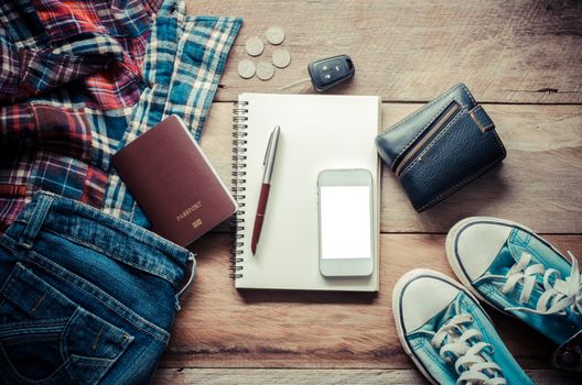 Travel accessories, shirts, jeans, shoes, passports, smart phone,car keys, wallet, notebook and pen for the trip.