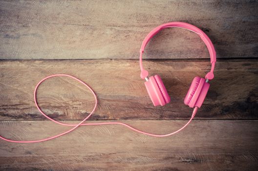 Pink headphones on the wooden floor