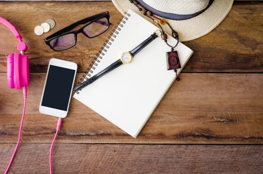accessories, glasses,notebook, watch, smart phone, earphone, notebook, on the wood