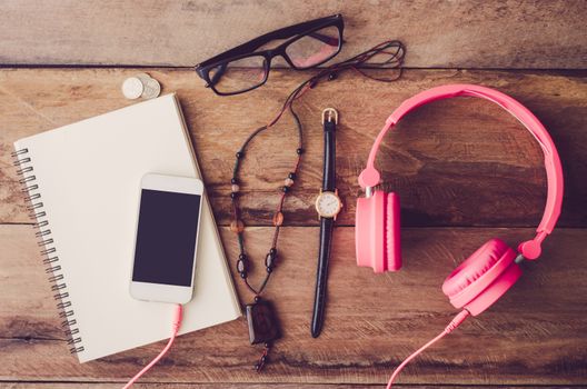 accessories, glasses,glove, notebook, watch, smart phone, on the wood