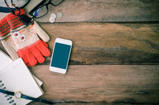 accessories, glasses,glove, notebook, watch, smart phone, on the wood