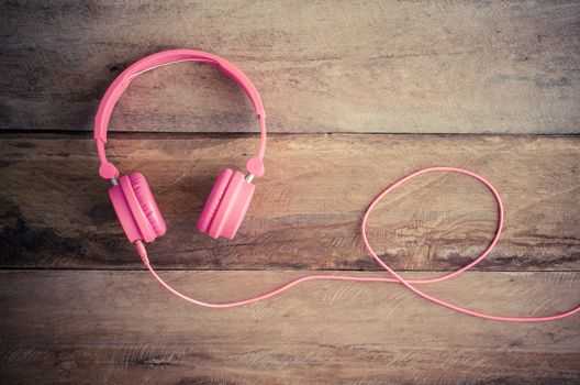 Pink headphones on the wooden floor