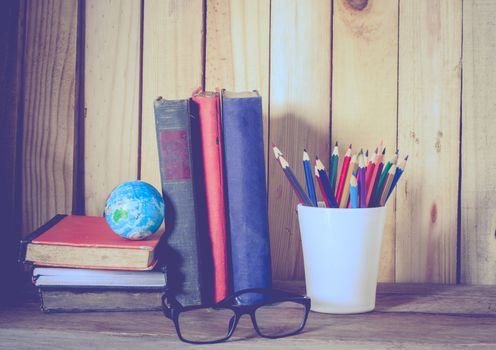 Still life color pencil and books on wooden background