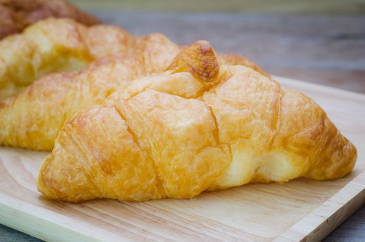 Croissants on plate on wooden table