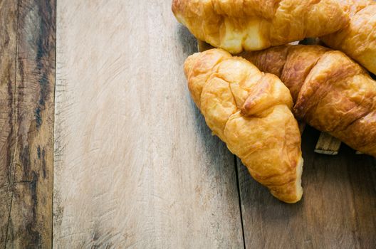 Croissants on plate on wooden table