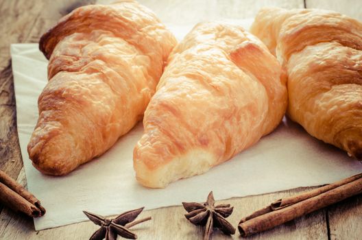 Croissants on plate on wooden table